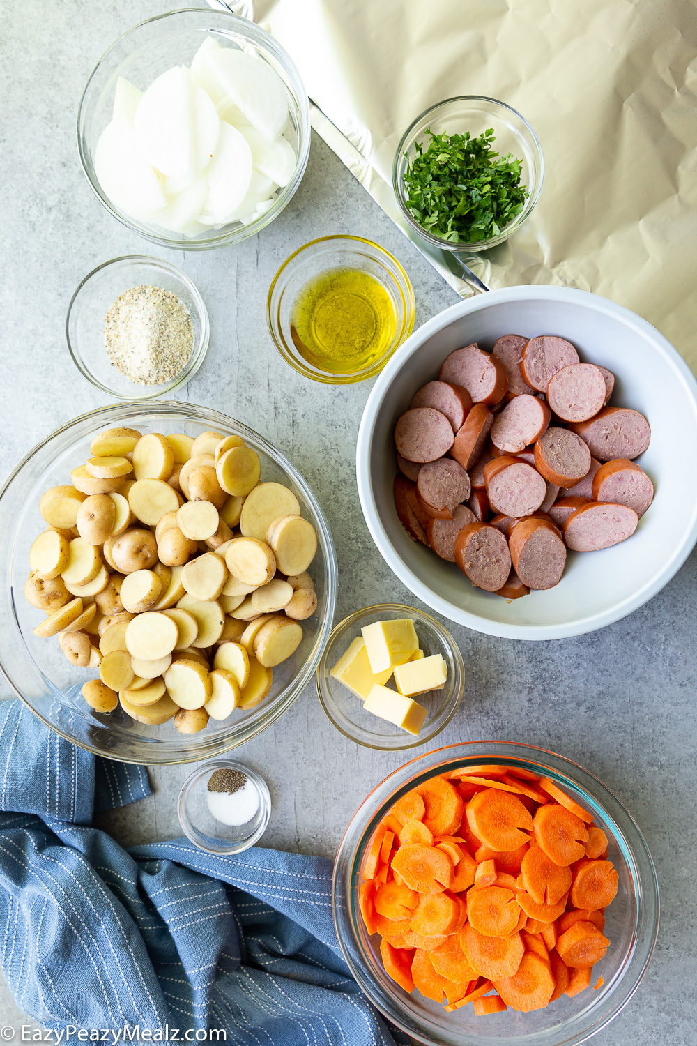 The ingredients needed to make sausage and potato foil packs. 