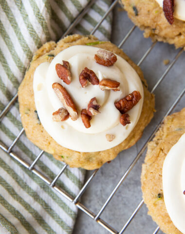 Zucchini cookies, a tender cookie studded with zucchini, and topped with cream cheese frosting and pecans.