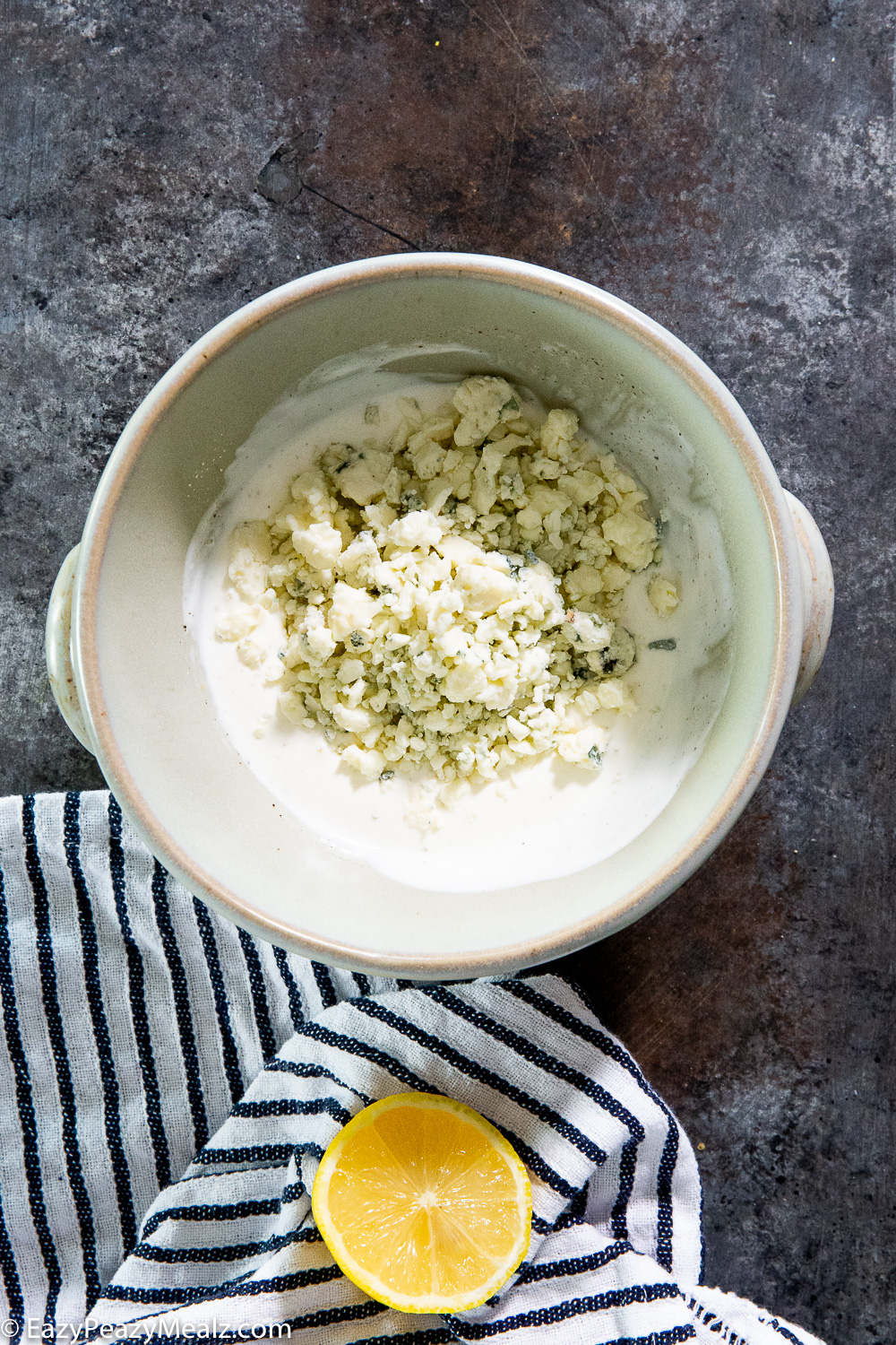 Adding blue cheese to blue cheese dressing. 
