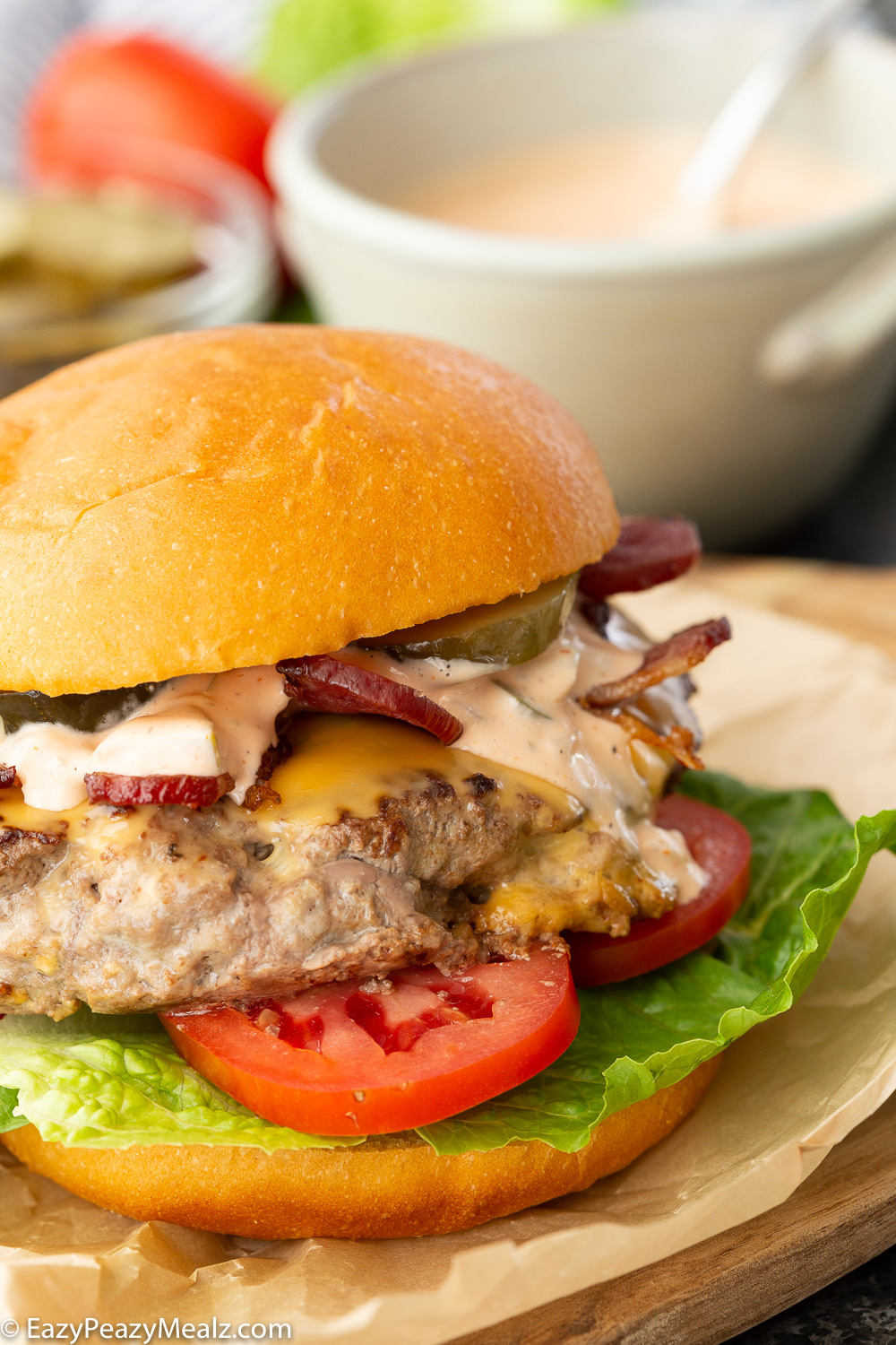 Homemade burger sauce on a bacon cheeseburger. 