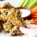 Crispy Garlic Parmesan Chicken Wings: these crispy baked chicken wings are tossed in a buttery herb garlic parmesan sauce.
