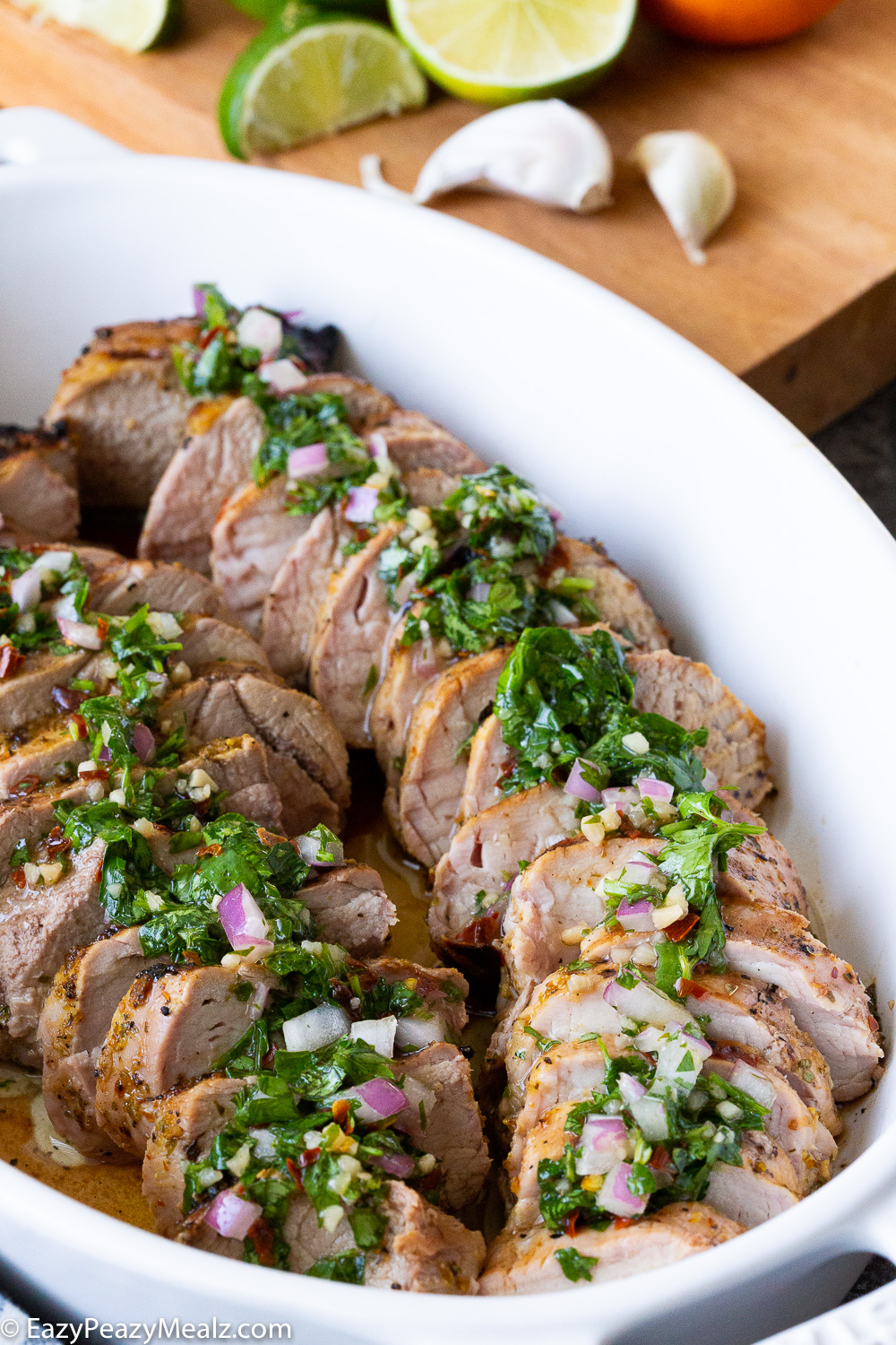 mojo pork tenderloin, a citrus marinated pork tenderloin that is grilled and topped with chimichurri