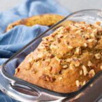 A loaf of banana nutbread in a glass pan