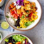 Chicken burrito bowls- Easy chicken burrito bowls packed with juicy seasoned chicken, rice, beans, veggies, and all your favorite toppings. A quick, customizable meal the whole family will love!