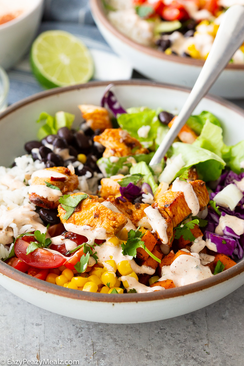 Chicken burrito bowls with hot honey chipotle chicken, sweet potatoes, black beans, cilantro lime rice and more