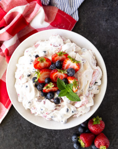 Vibrant Berry Cheesecake Salad bursting with fresh strawberries, blueberries, folded into a rich, creamy cheesecake filling—perfect for summer gatherings and potlucks.