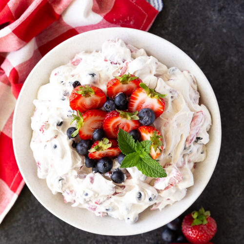 Vibrant Berry Cheesecake Salad bursting with fresh strawberries, blueberries, folded into a rich, creamy cheesecake filling—perfect for summer gatherings and potlucks.