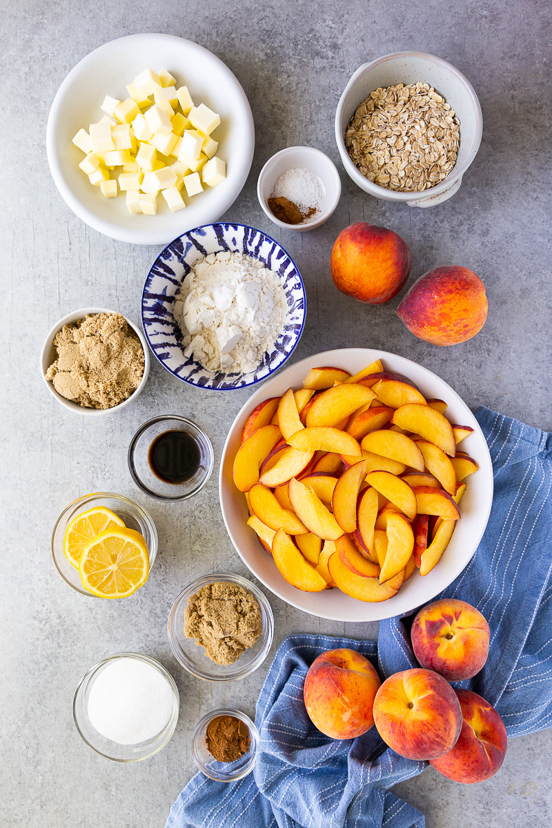 Simple ingredients for peach crisp: fresh or canned peaches, brown sugar, oats, flour, butter, and warm spices for a cozy, crowd-pleasing dessert.