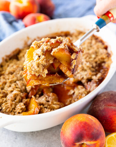 Golden, buttery peach crisp topped with a crisp oat crumble and served warm with a scoop of melting vanilla ice cream.