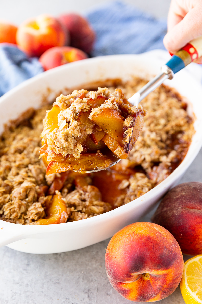 Golden, buttery peach crisp topped with a crisp oat crumble and served warm with a scoop of melting vanilla ice cream.