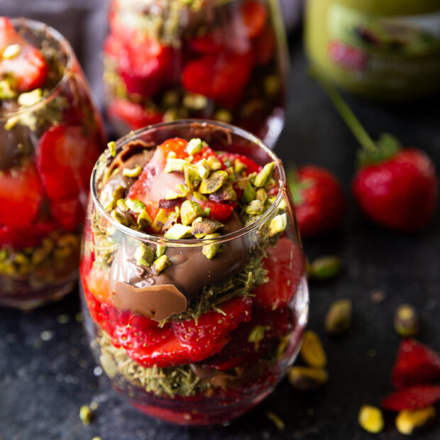 Decadent Dubai Chocolate Strawberry Cups layered with crispy kataifi pastry, creamy pistachio butter, fresh strawberries, and silky milk chocolate ganache, beautifully served in elegant glass cups.