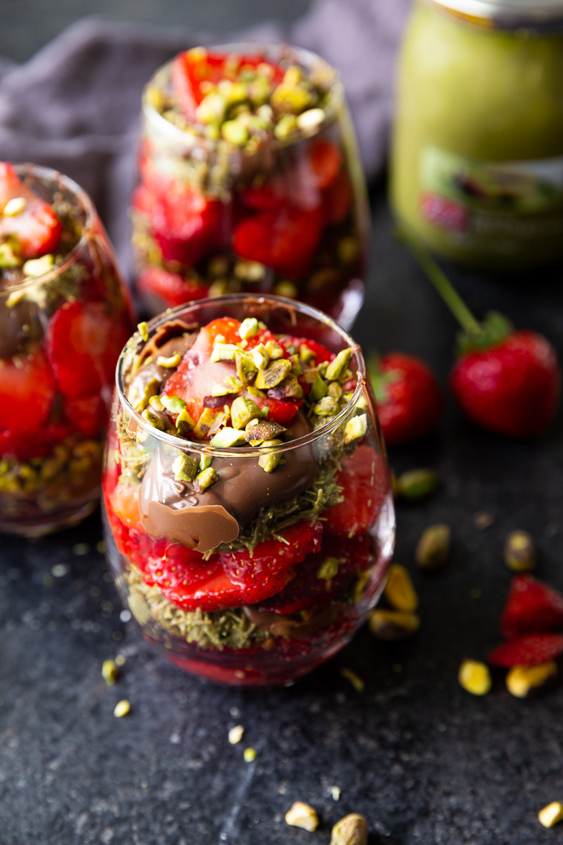 Decadent Dubai Chocolate Strawberry Cups layered with crispy kataifi pastry, creamy pistachio butter, fresh strawberries, and silky milk chocolate ganache, beautifully served in elegant glass cups.