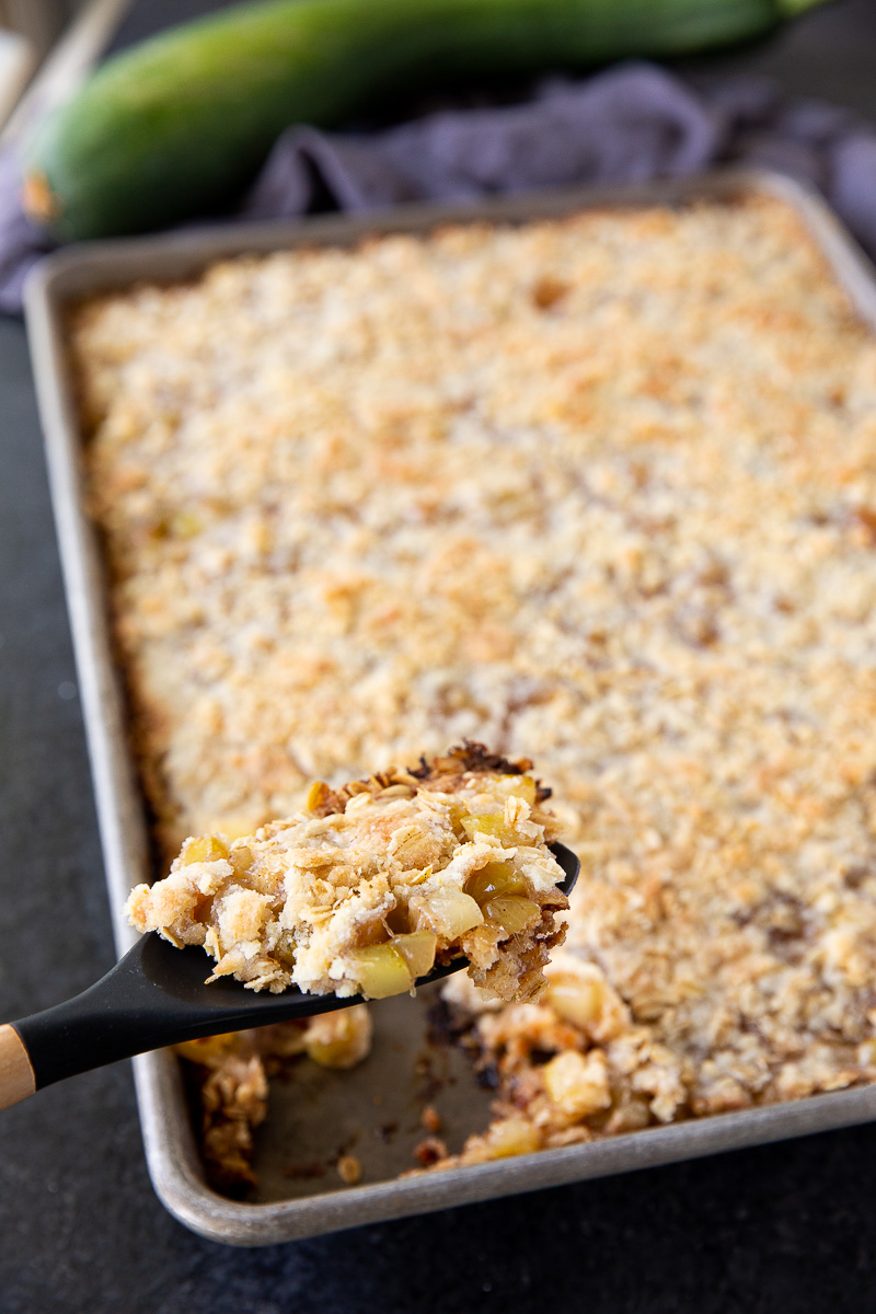 Made with diced zucchini, lemon juice, sugar, warm spices, and a buttery flour-based crumb topping, these simple ingredients come together to create a dessert that tastes just like classic apple crisp.