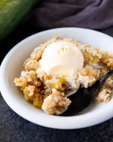This zucchini crisp tastes just like apple crisp but uses summer zucchini instead! A sweet, cinnamon-spiced dessert with a buttery crumb topping—perfect for using up garden zucchini.