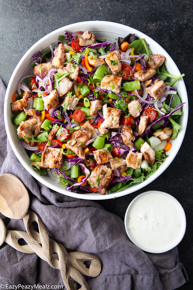 Make dinner fresh and delicious with this BBQ Chicken Salad featuring grilled chicken, spring mix, vibrant veggies, and creamy ranch dressing.