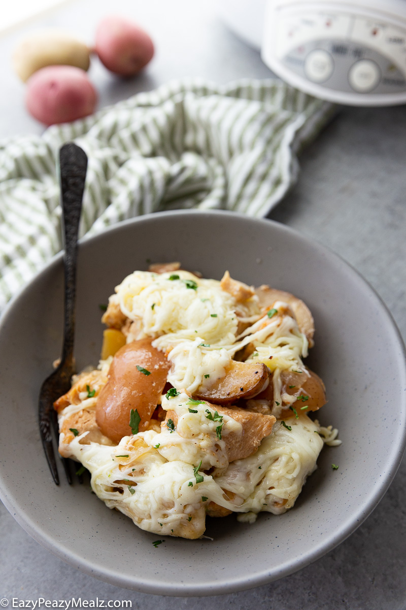 Make dinnertime easy with this Slow Cooker Garlic Parmesan Chicken and Potatoes recipe! Juicy chicken, tender potatoes, and a rich garlic-parmesan sauce come together in one comforting, family-friendly meal.
