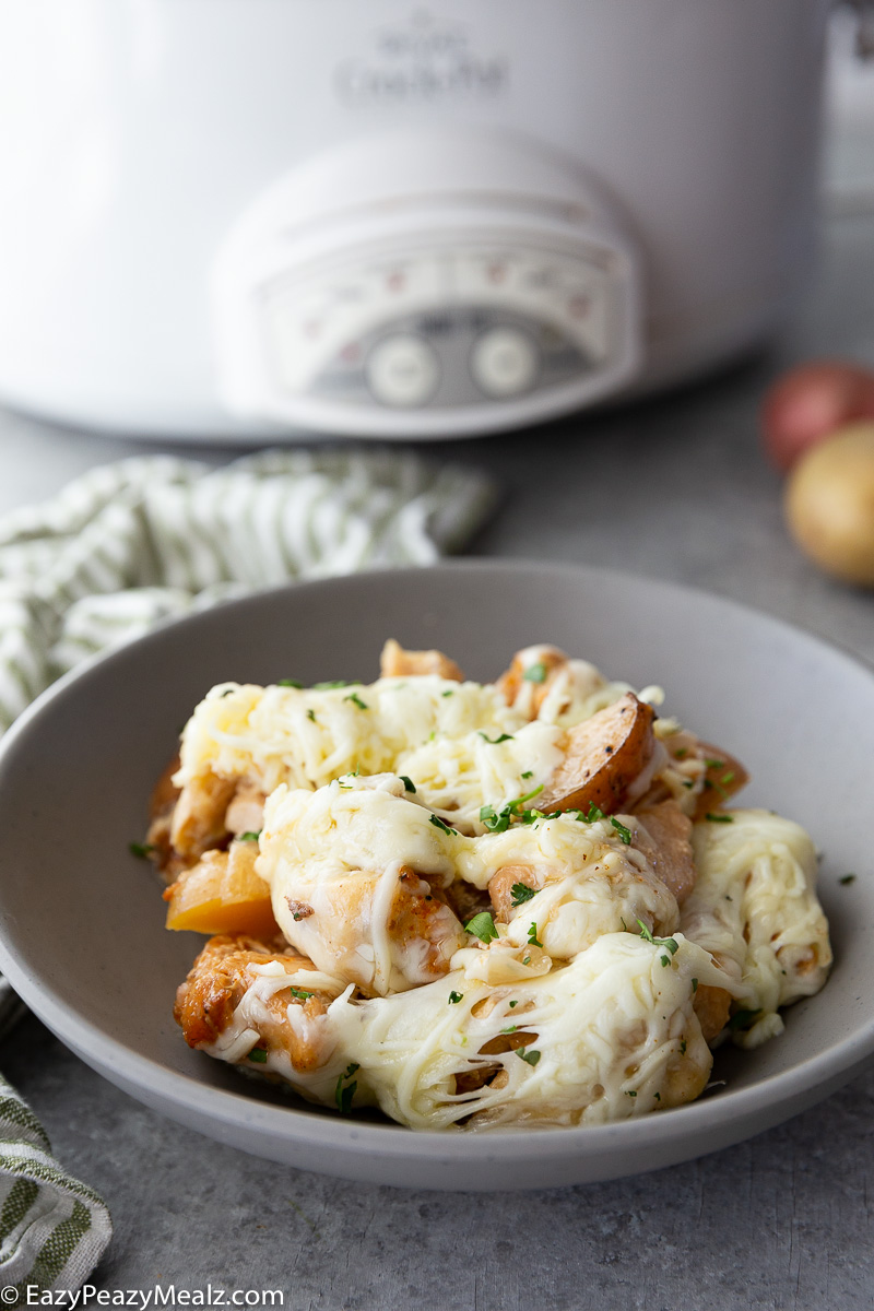 A bowl full of garlic parmesan chicken and potatoes