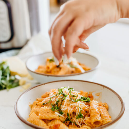 Garnishing instant pot rigatoni with a creamy tomato sauce