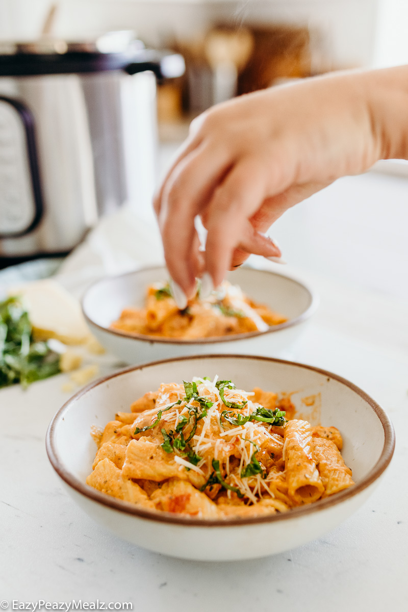 Garnishing instant pot rigatoni with a creamy tomato sauce