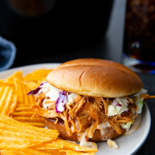 Tender, juicy slow cooker zesty BBQ chicken shredded and coated in a rich, tangy barbecue sauce, perfect for sandwiches, wraps, or weeknight dinners.