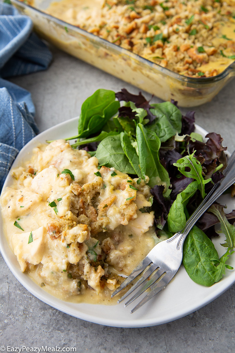 Chicken stuffing casserole plated with a green salad.