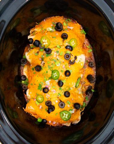 Slow Cooker chicken enchiladas topped