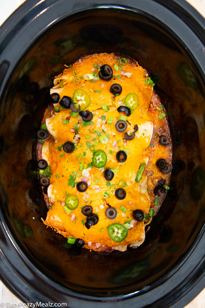 Slow Cooker chicken enchiladas topped