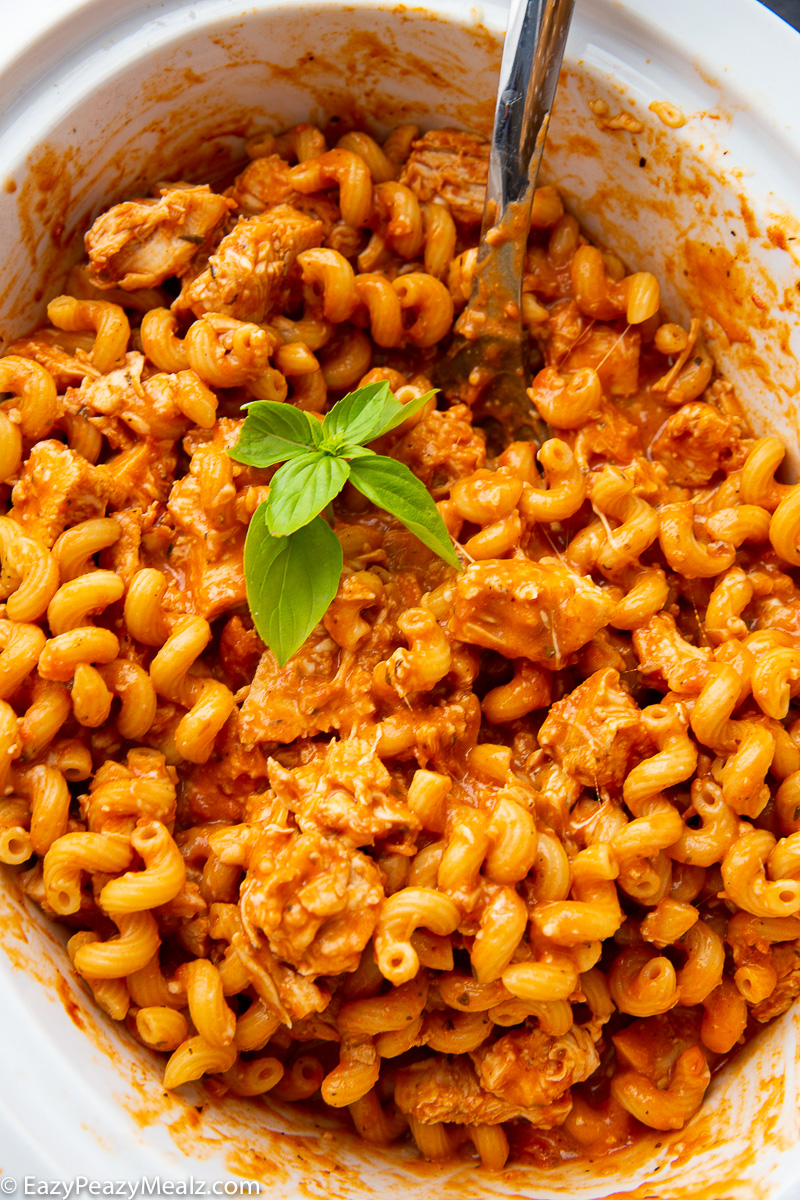 A slow cooker full of chicken pasta