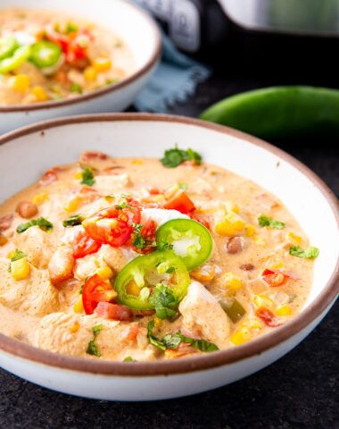Slow Cooker creamy chicken taco soup in a bowl with toppings