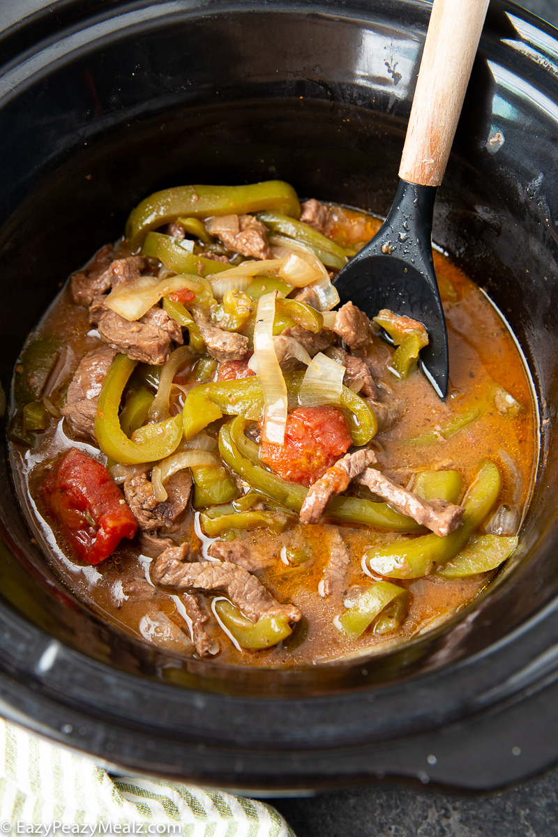 Slow cooker pepper steak cooked in the slow cooker. 