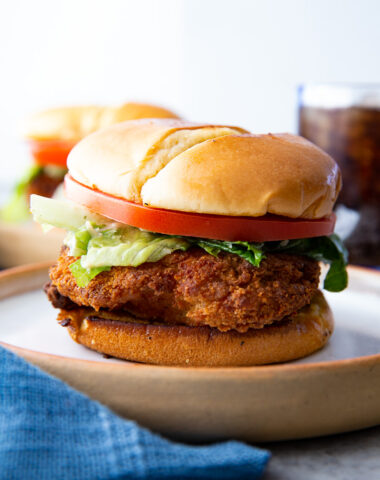 Caesar Chicken Sandwich, a crispy chicken filet with caesar salad, tomatoes, and a toasted bun.