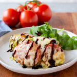 Caprese Chicken, baked chicken with pesto, mozzarella, and tomatoes with balsamic glaze.