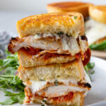 Chicken parm sandwiches, layers of chicken, parmesan, mozzarella, and sauce.