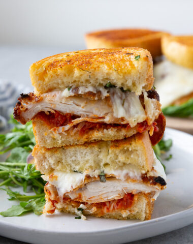 Chicken parm sandwiches, layers of chicken, parmesan, mozzarella, and sauce.