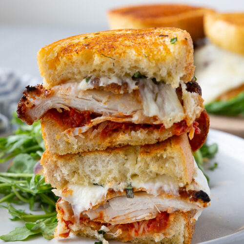 Chicken parm sandwiches, layers of chicken, parmesan, mozzarella, and sauce.