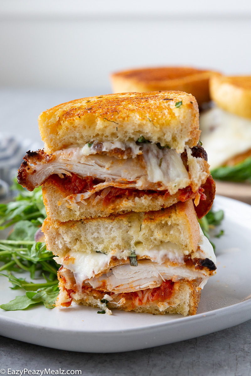 Chicken parm sandwiches, layers of chicken, parmesan, mozzarella, and sauce.