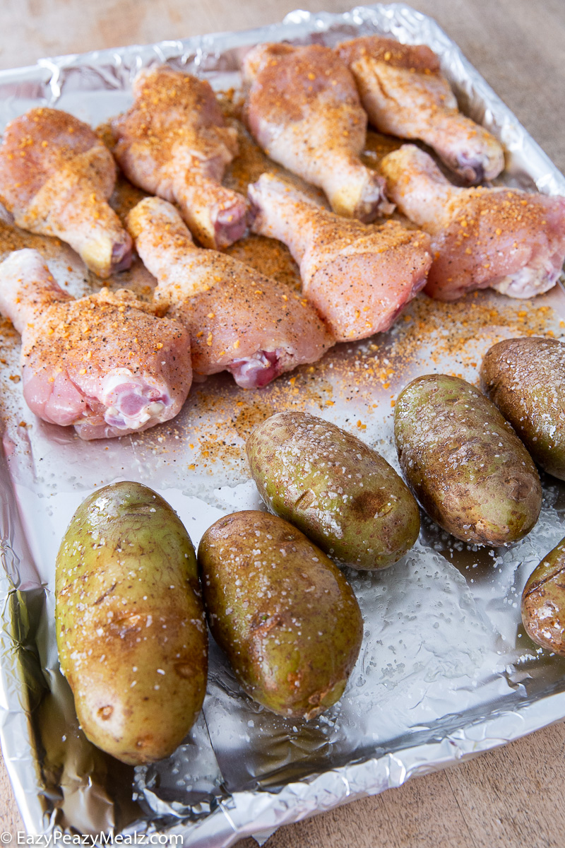 Baking a sheet pan of bbq drumsticks and potatoes
