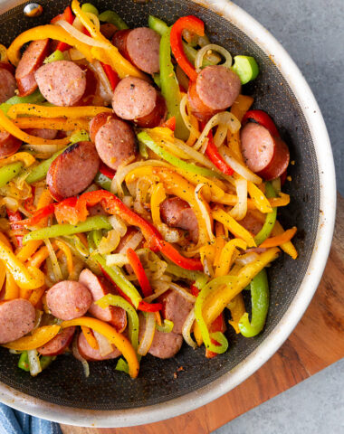 A skillet full of sausage and peppers