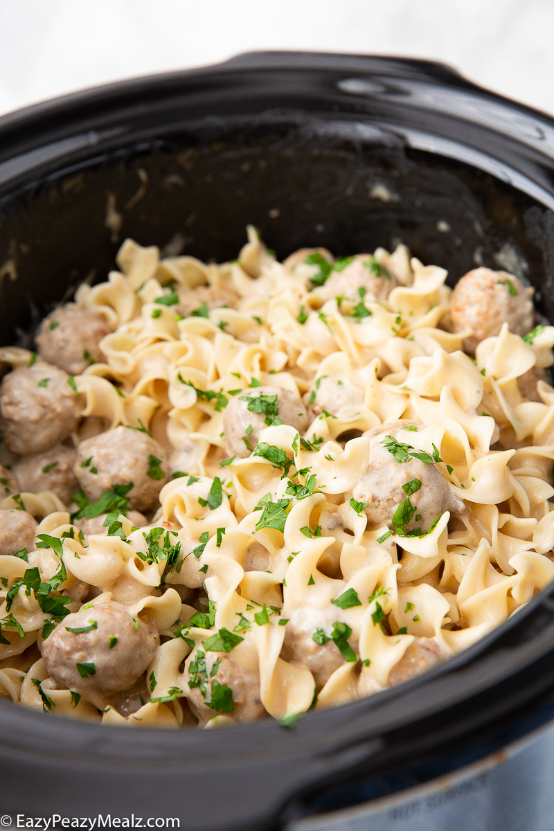 Slow Cooker Swedish Meatballs garnished with parsley. 