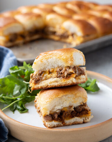 A plate with taco sliders, cheesy, beefy, and tasty.