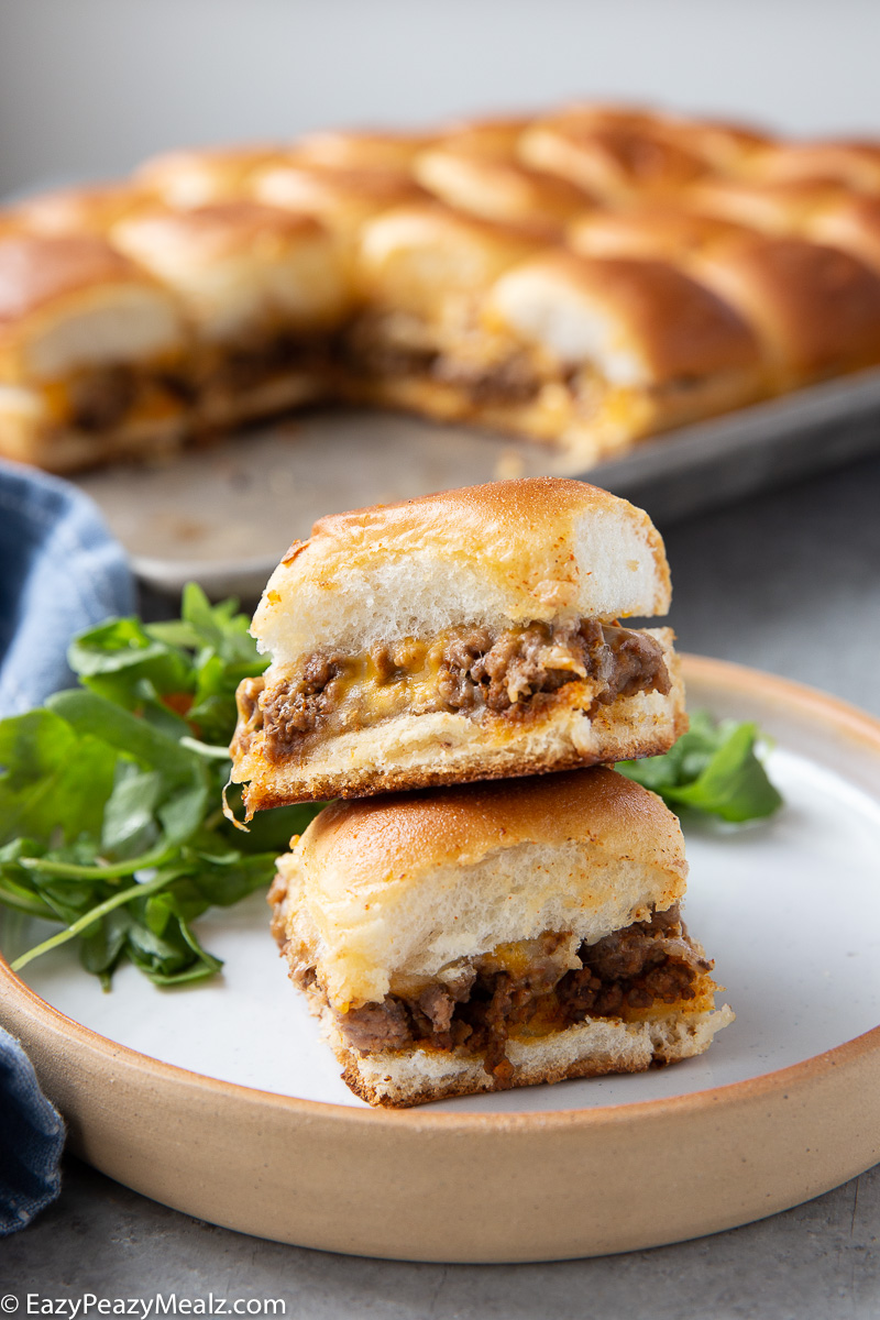 A plate with taco sliders, cheesy, beefy, and tasty.