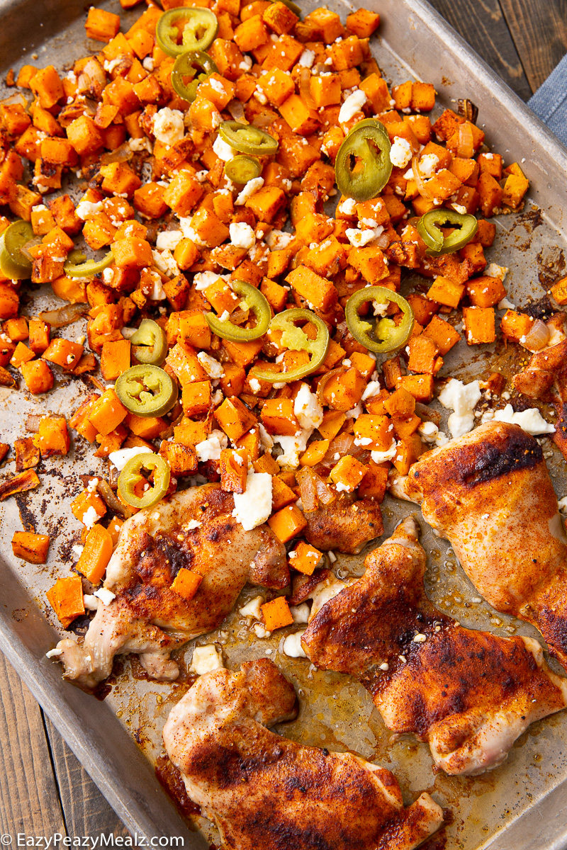 A sheet pan full of hot honey chicken and sweet potatoes. 
