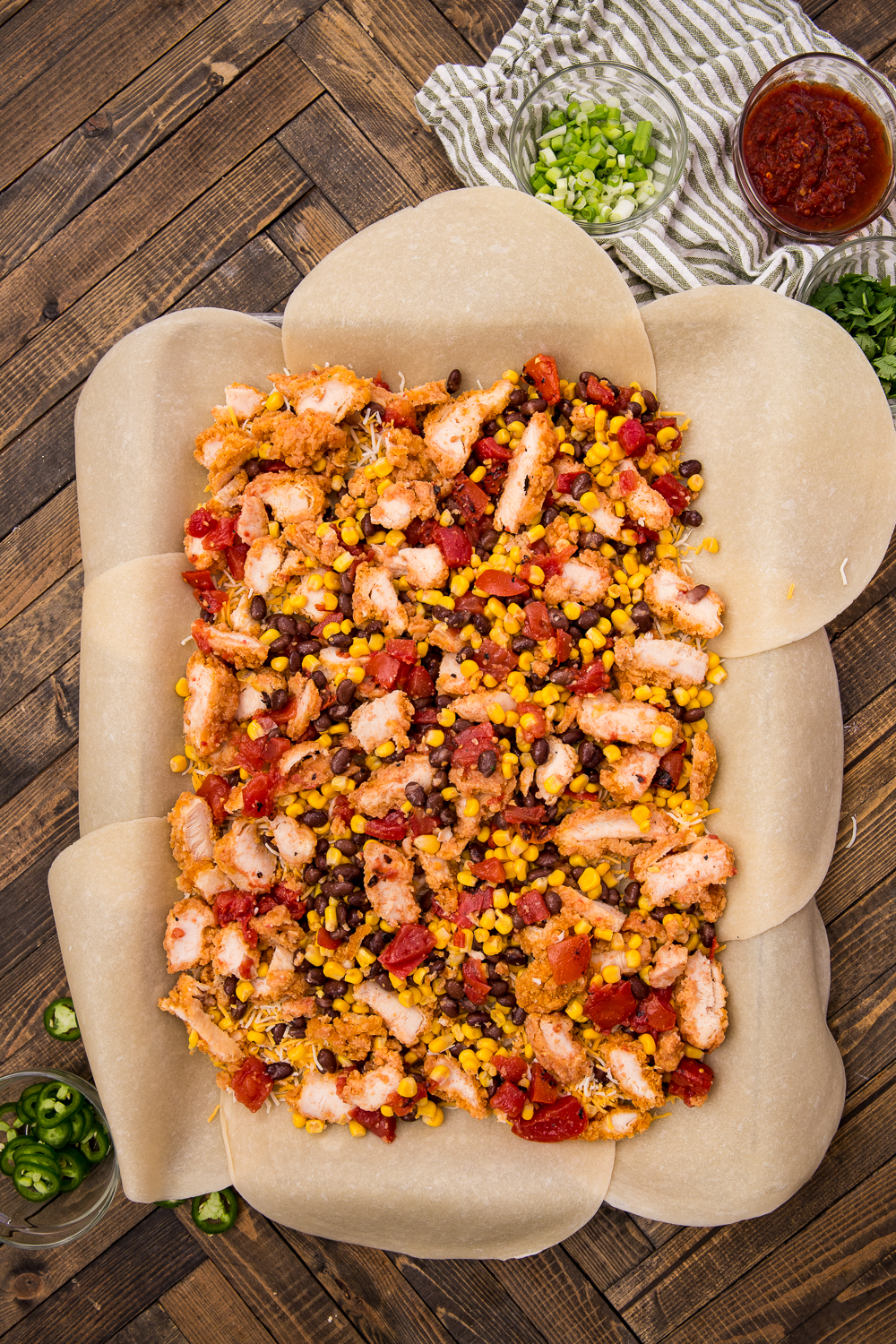 sheet pan chicken quesadillas being assembled 