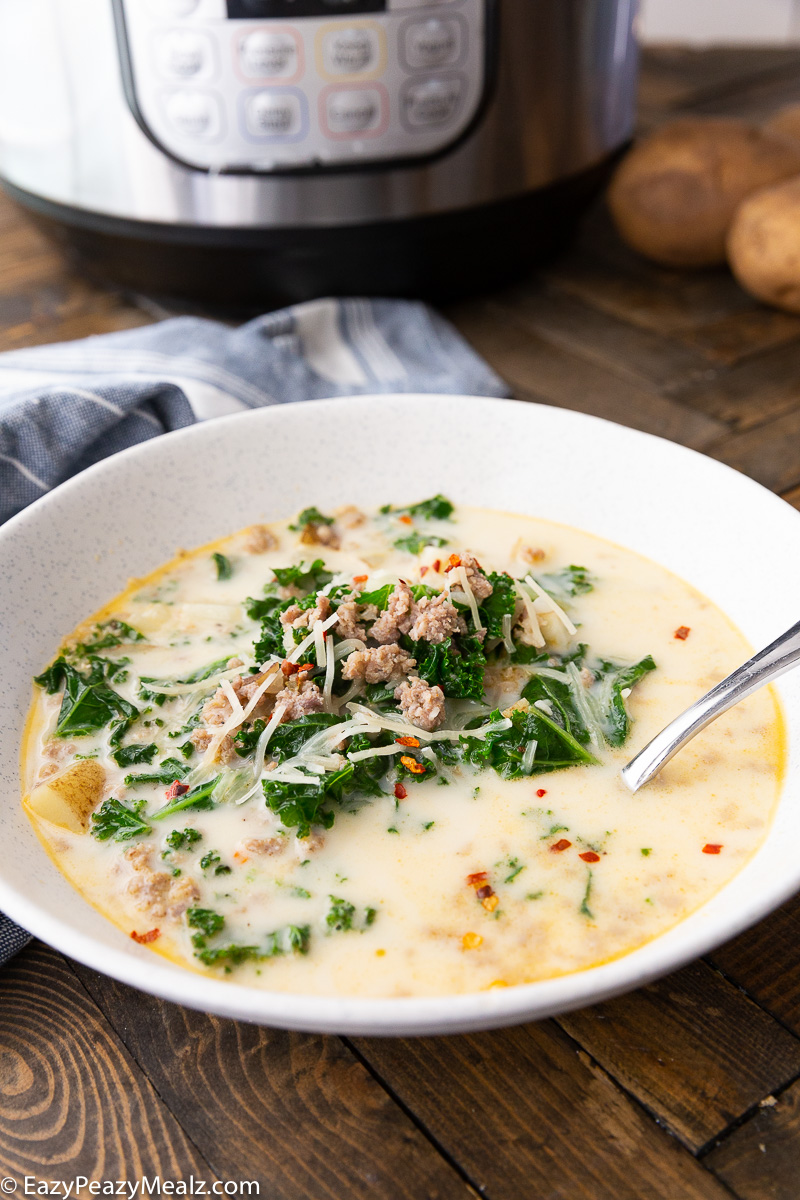 Instant Pot Zuppa Toscana, a bowl full with an instant pot in the background. 
