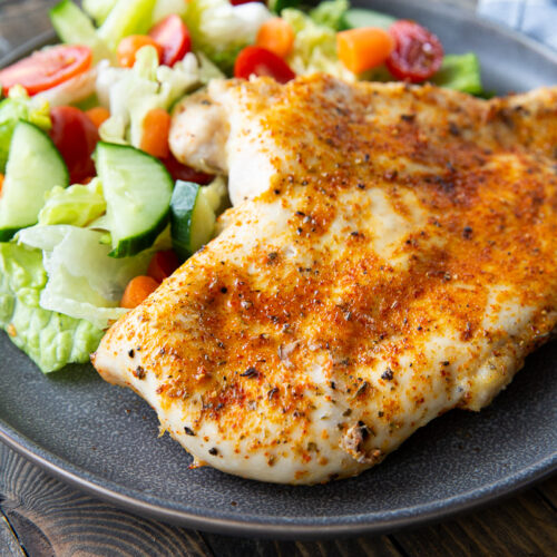 A plate of juicy baked chicken breasts
