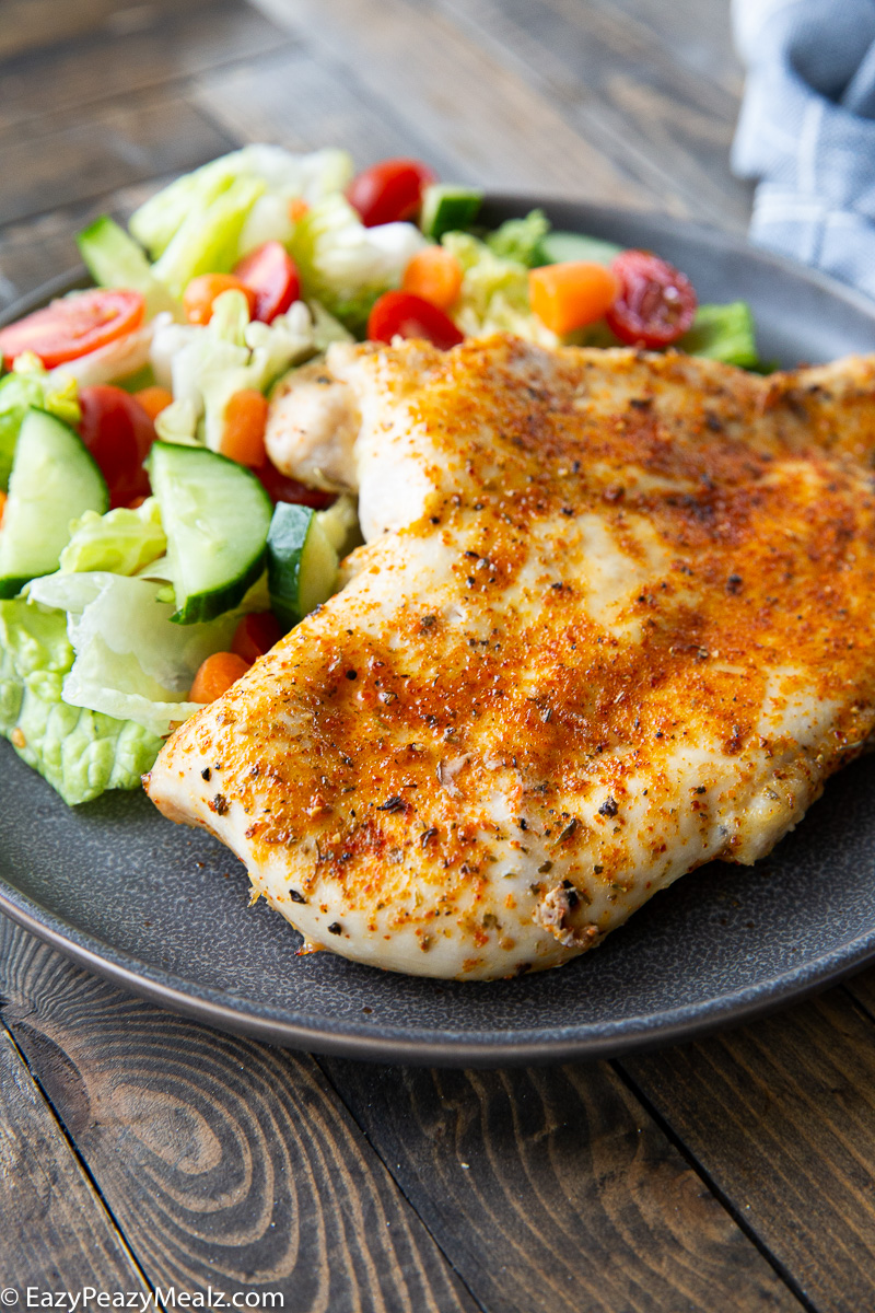 A plate of juicy baked chicken breasts