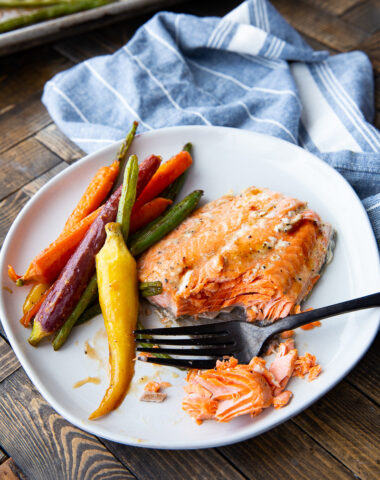 Maple Dijon Salmon cooked on a sheet pan with carrots and green beans.