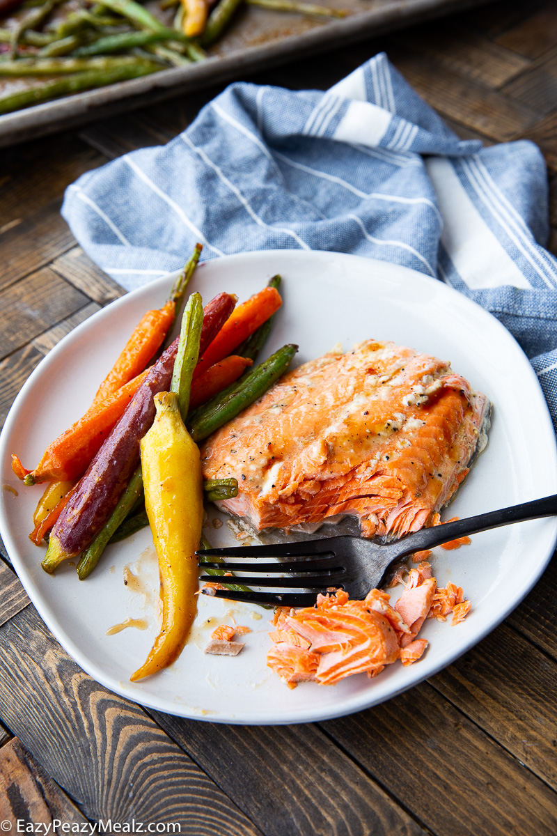 Maple Dijon Salmon cooked on a sheet pan with carrots and green beans. 