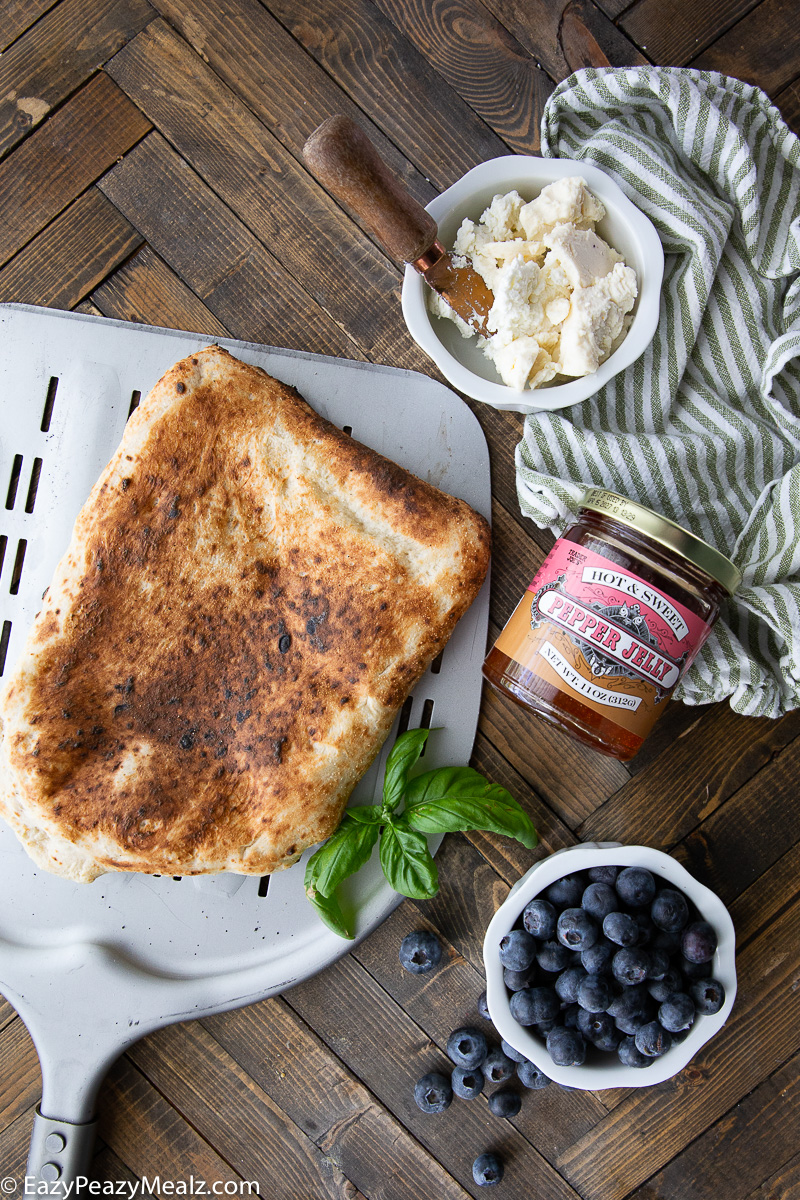 The toppings needed for this blueberry goat cheese flatbread
