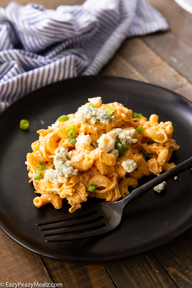 Buffalo chicken mac and cheese topped with blue cheese crumbles